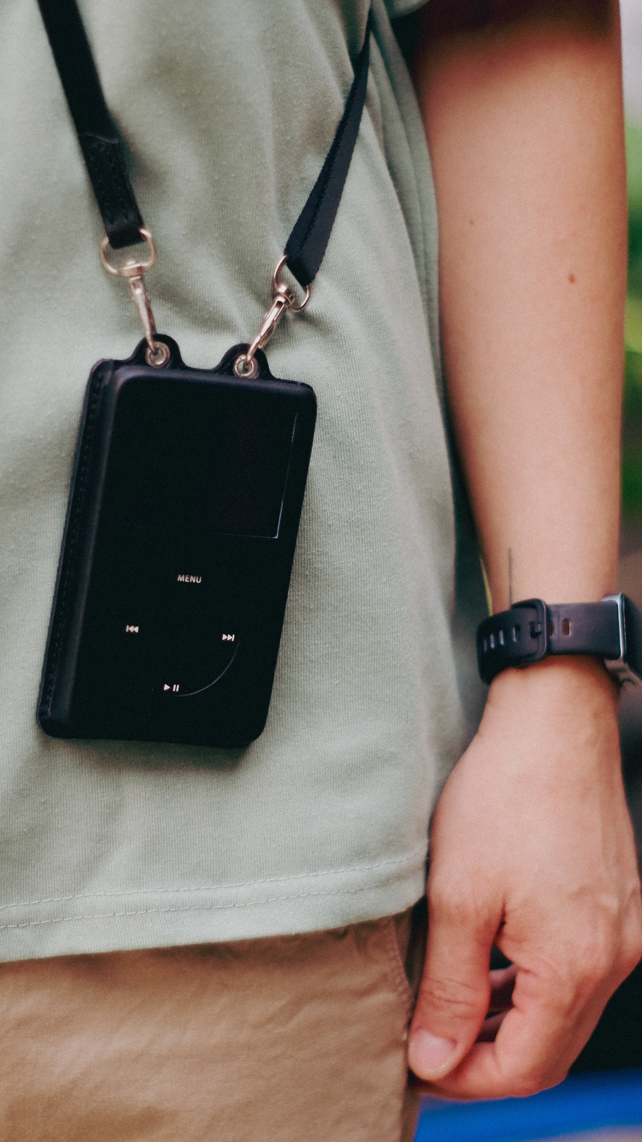 Person wearing minimalist case with strap | Atomic Faceplates